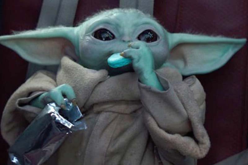 Baby yoda eating a blue cookie