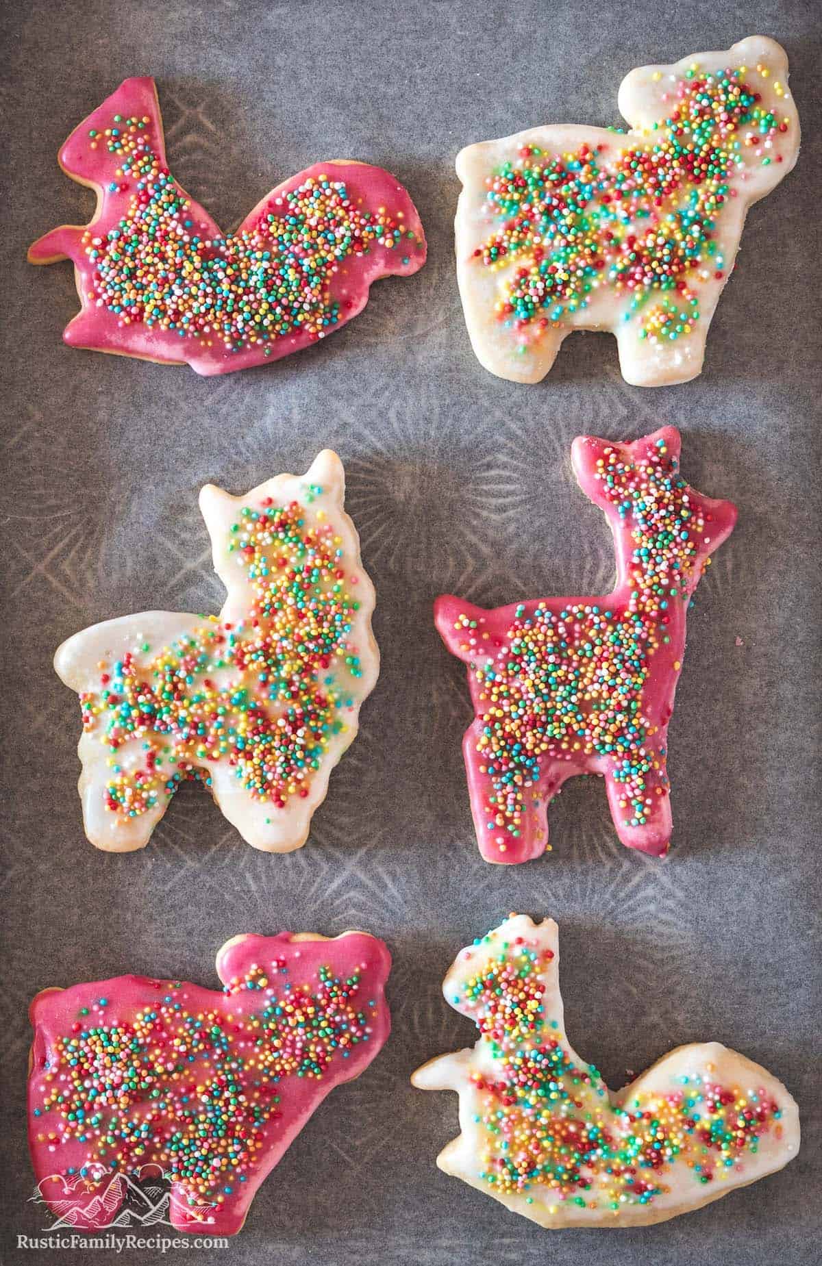 Frosted animal crackers shaped like a squirrel, deer and sheep