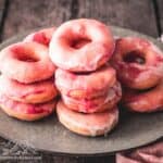 Stack of pink homemade donuts on a plate