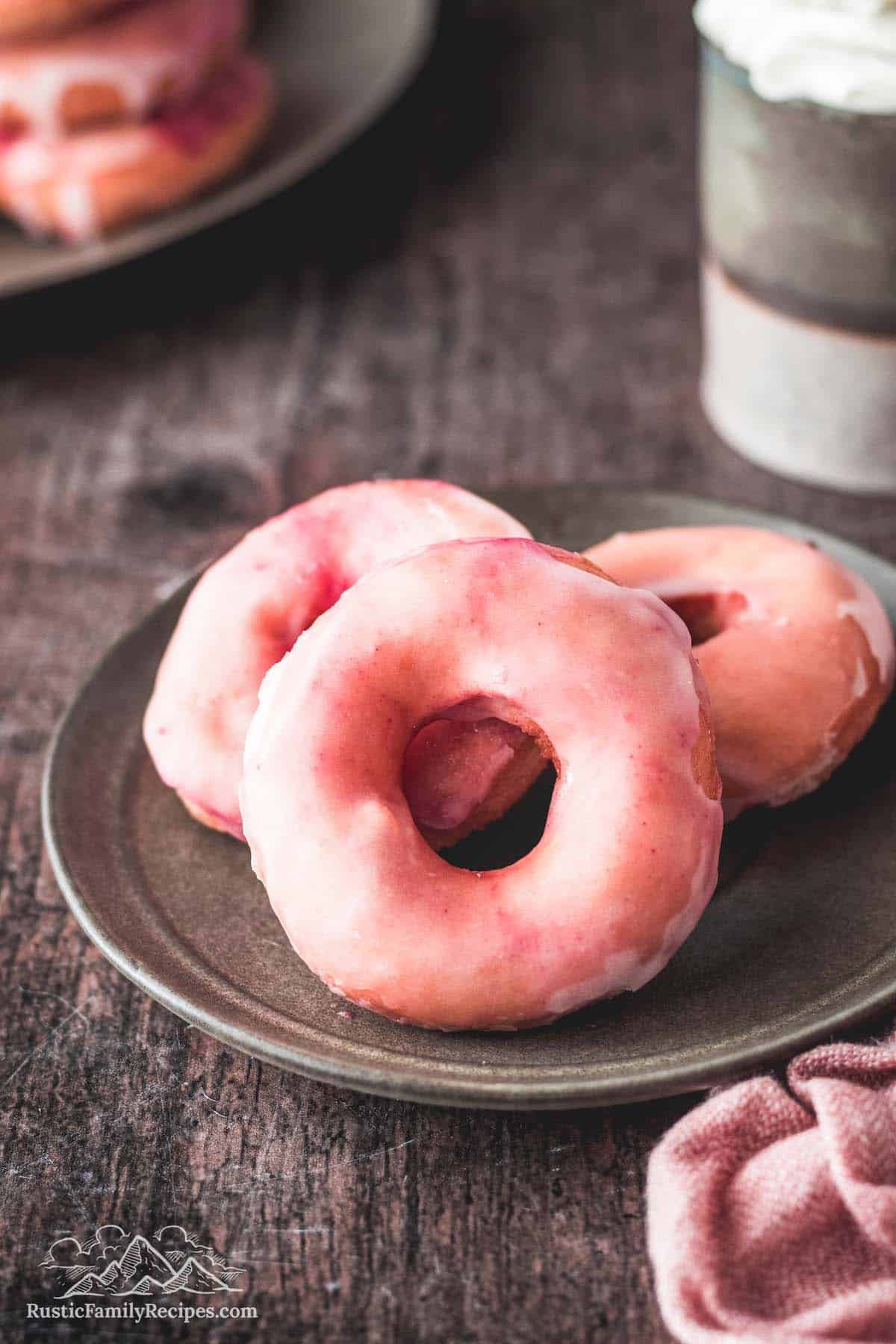 3 pink donuts on a plate