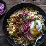 Top view of a bowl of birria ramen topped with egg
