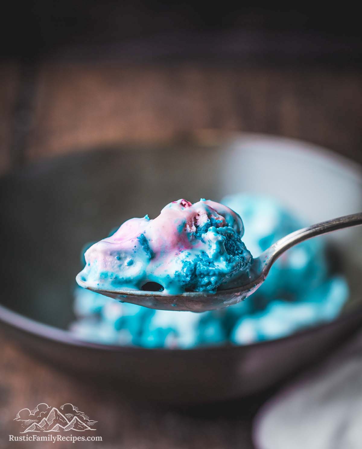 A scoop of homemade cotton candy ice cream on a spoon