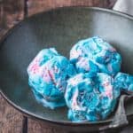 A rustic bowl with three scoops of cotton candy ice cream