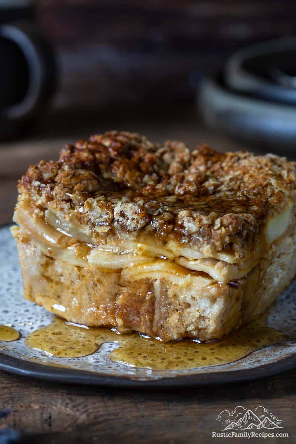 A slice of french toast casserole drenched in maple syrup