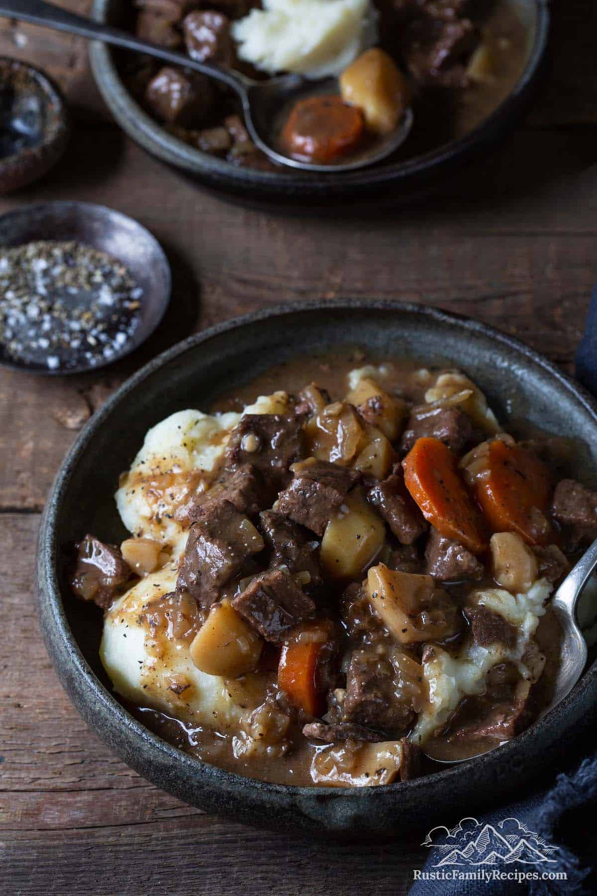 Two bowls of deer meat stew with mashed potatoes