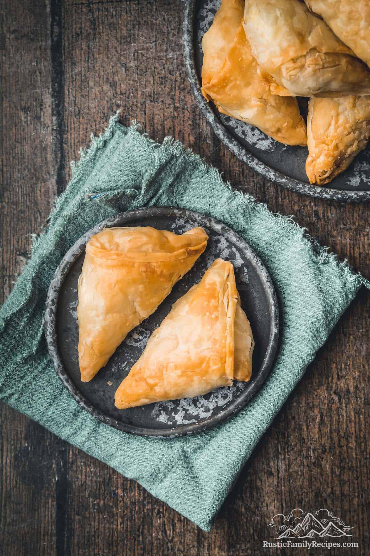 two greek feta hand pies on a plate
