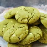 A plate with green matcha white chocolate chip cookies
