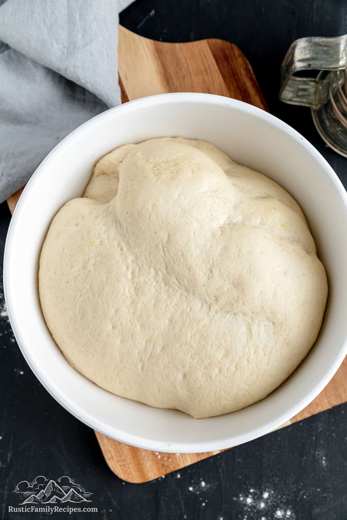 A white bowl with risen bread dough
