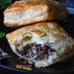 Close up of the ground venison filling inside a flaky homemade meat pie.
