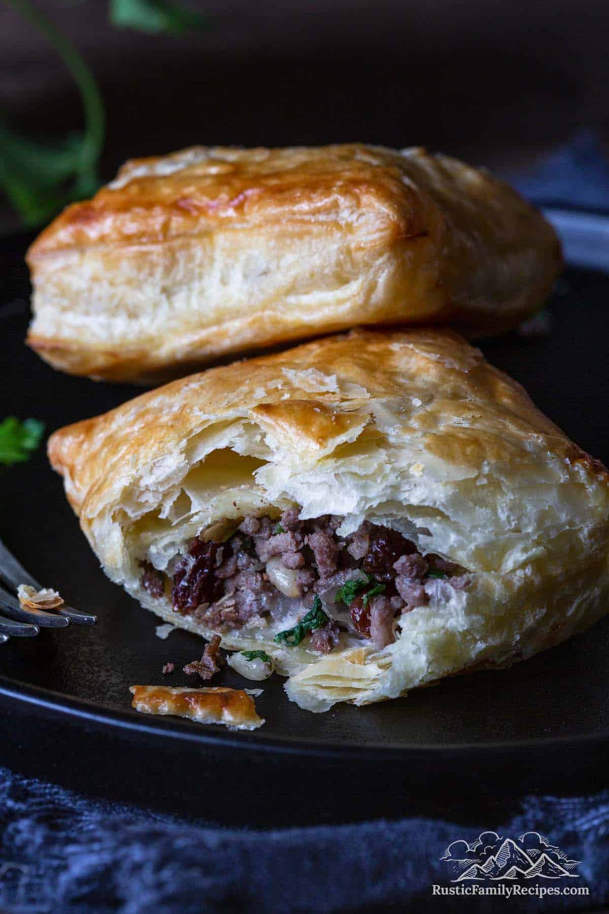 Close up of the ground venison filling inside a flaky homemade meat pie.