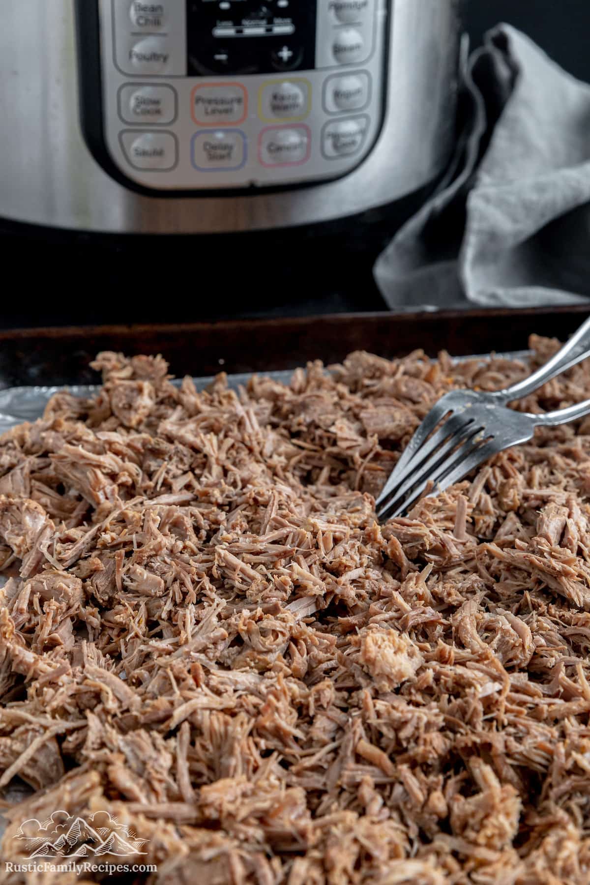 Pork carnitas being shredded after coming out of the instant pot
