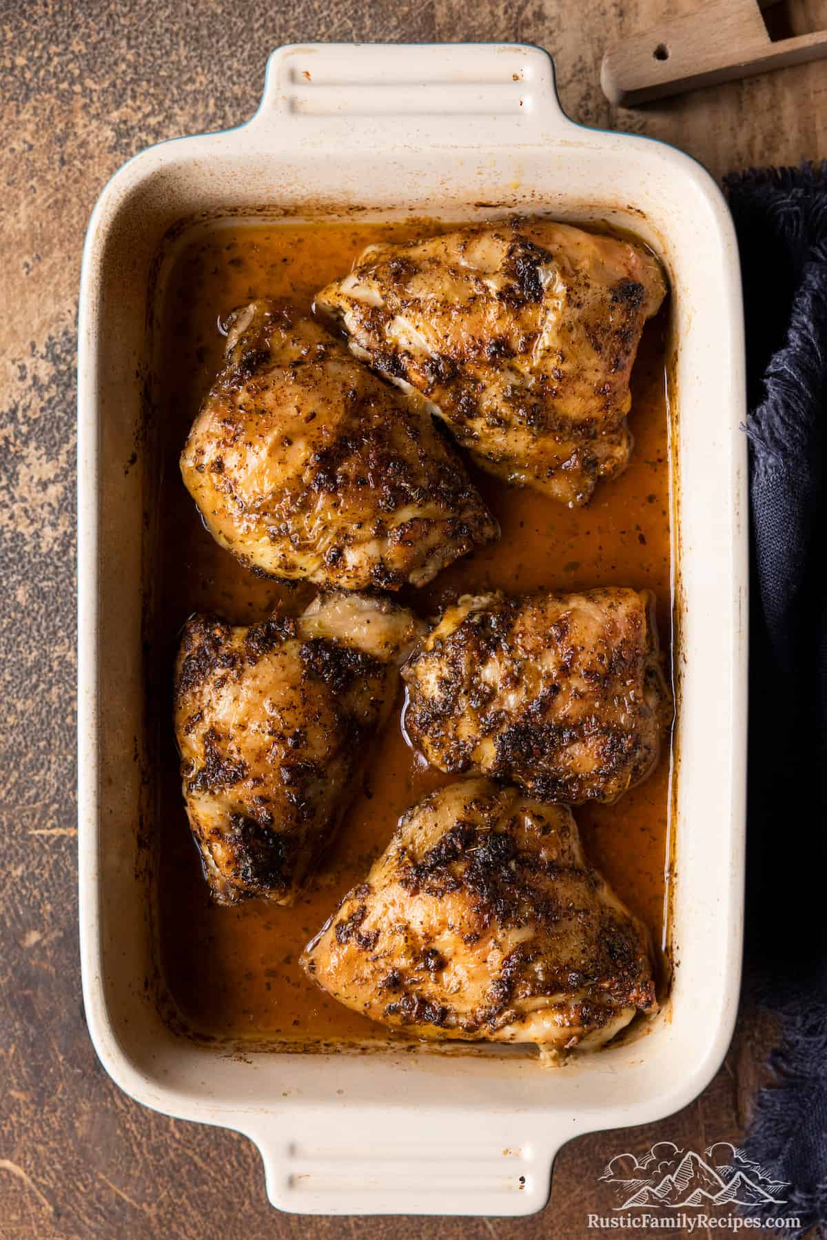 5 baked chicken thighs in a baking dish