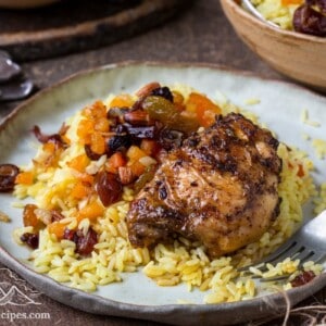 Saffron rice on a plate with chicken thighs