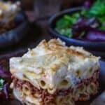 A slice of pastitsio with all its pasta, meat, and béchamel layers.