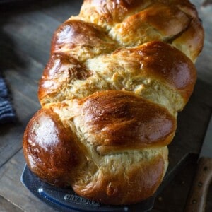 A loaf of braided challah in a bread pan