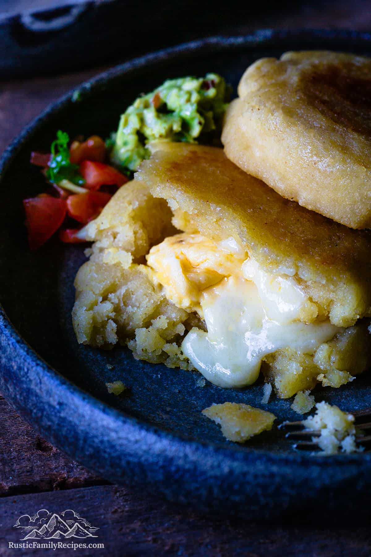 Arepas stuffed with scrambled eggs and cheese on a plate