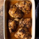 5 baked chicken thighs in a baking dish
