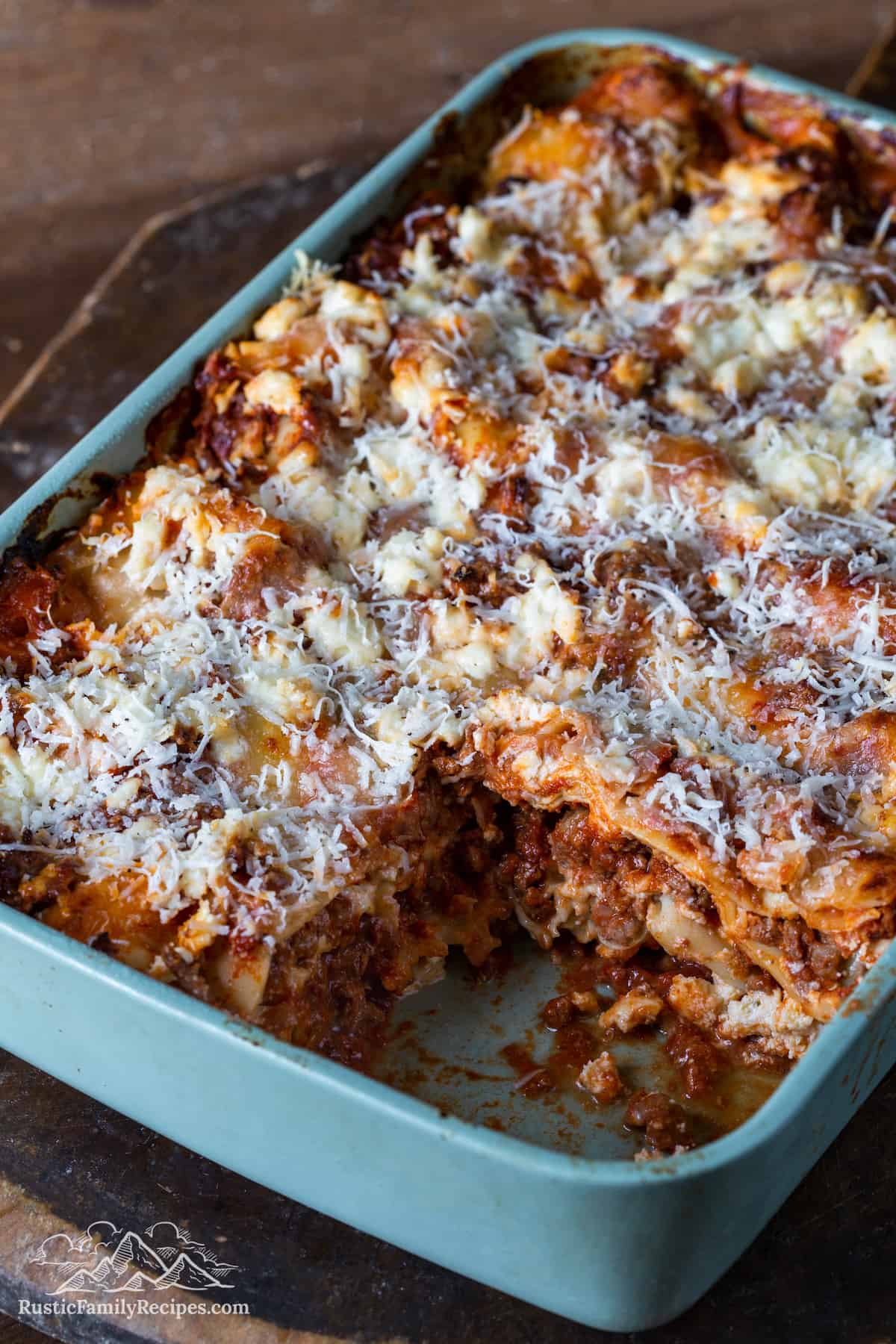 Lasagna in a baking dish with a slice taken out