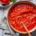 Pasta sauce in a skillet with a spoon