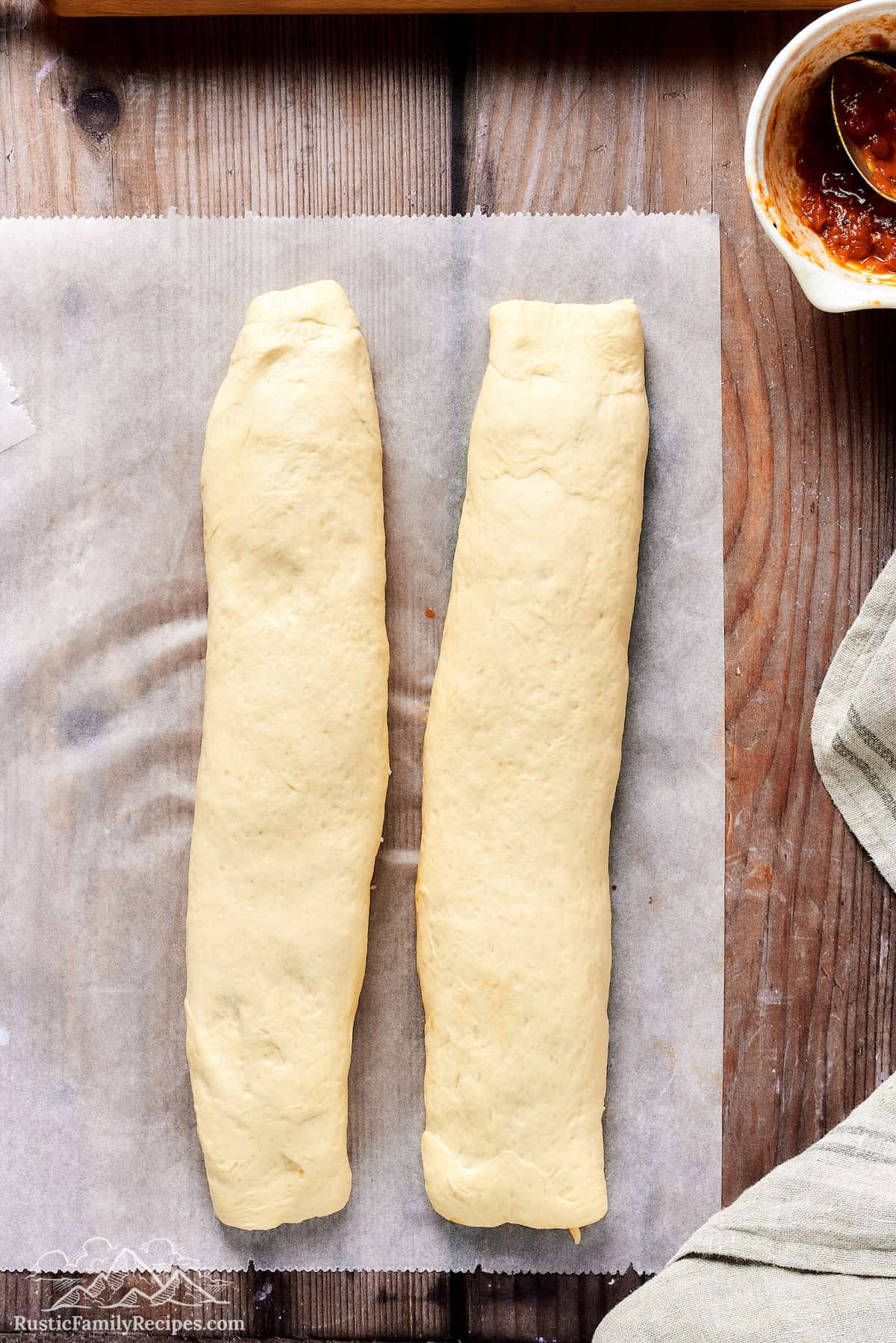 Two rolls up pizza dough pieces with sauce and cheese inside