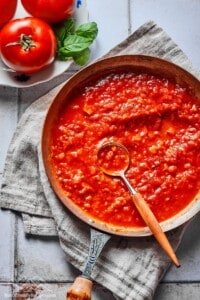 Pasta sauce in a skillet with a spoon