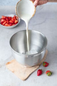 Pouring ingredients into a stand mixer bowl