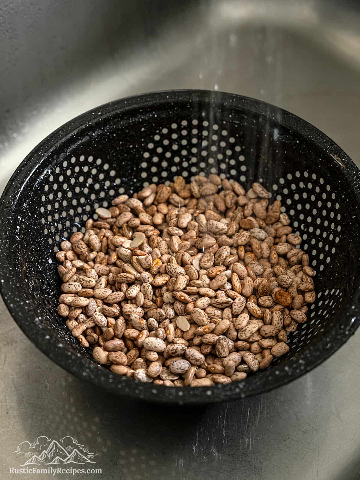 Rinsing pinto beans in a colander