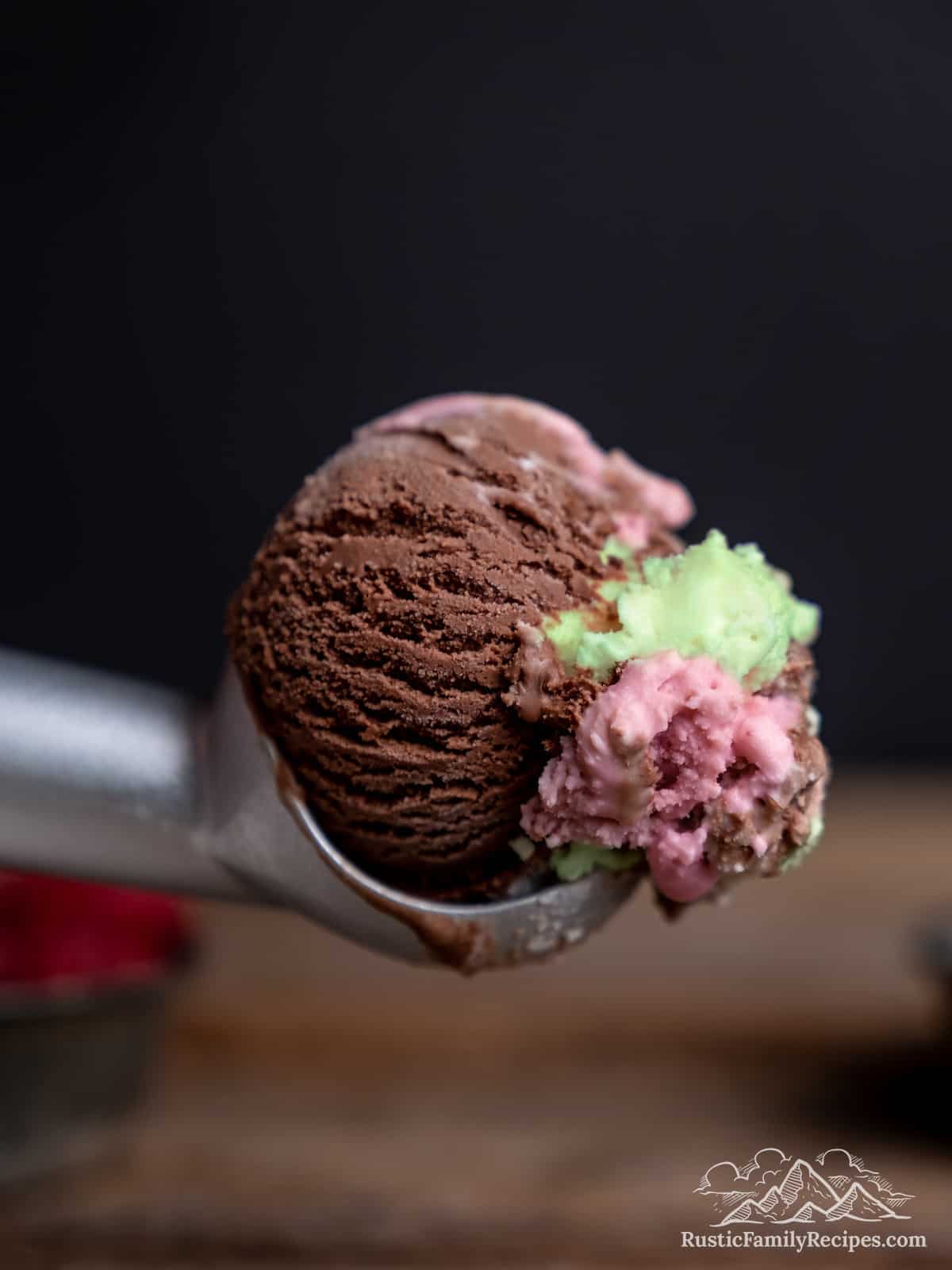 A scoop of spumoni ice cream in an ice cream scoop.