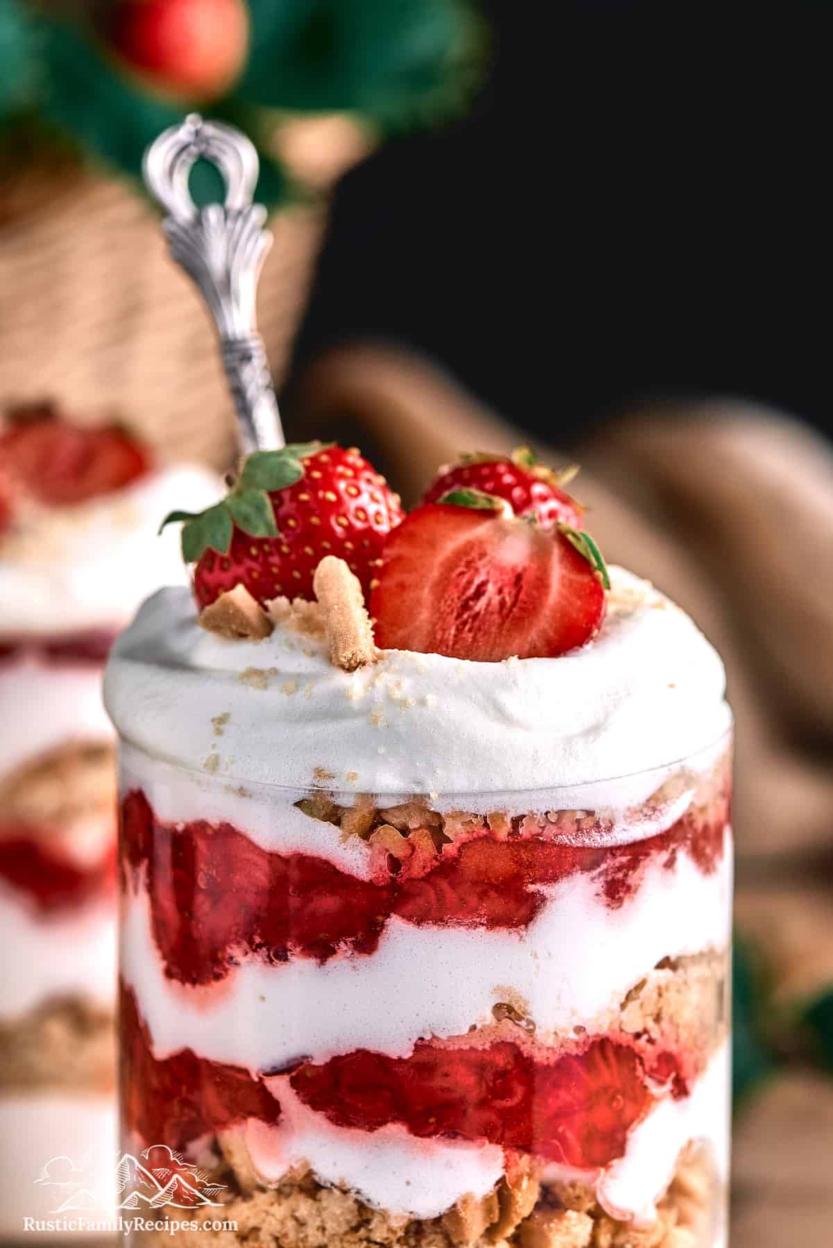 Close up of Strawberries Romanoff parfait in a glass with a spoon