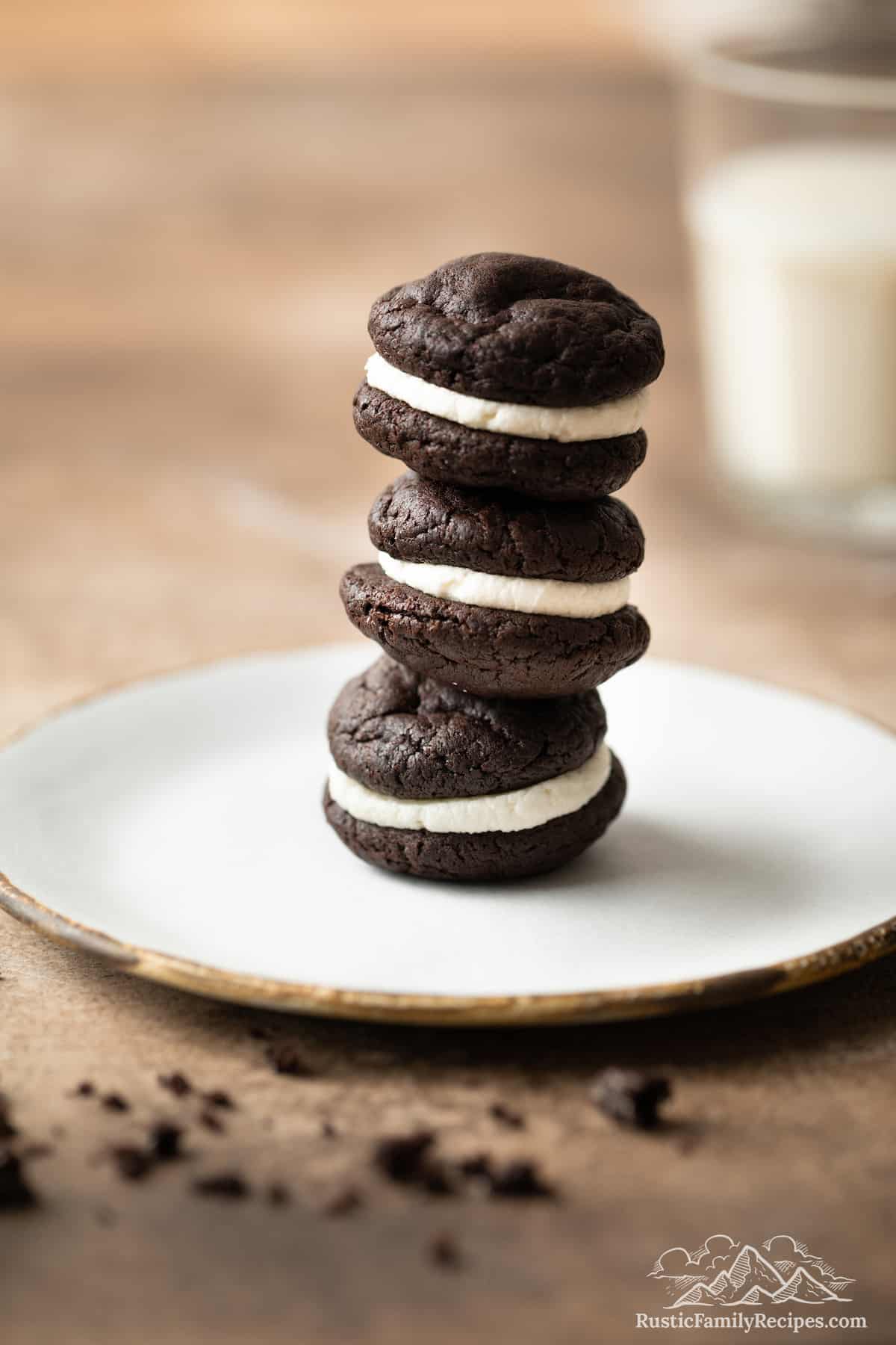 A stack of three Oreo whoopie pies on a white plate.