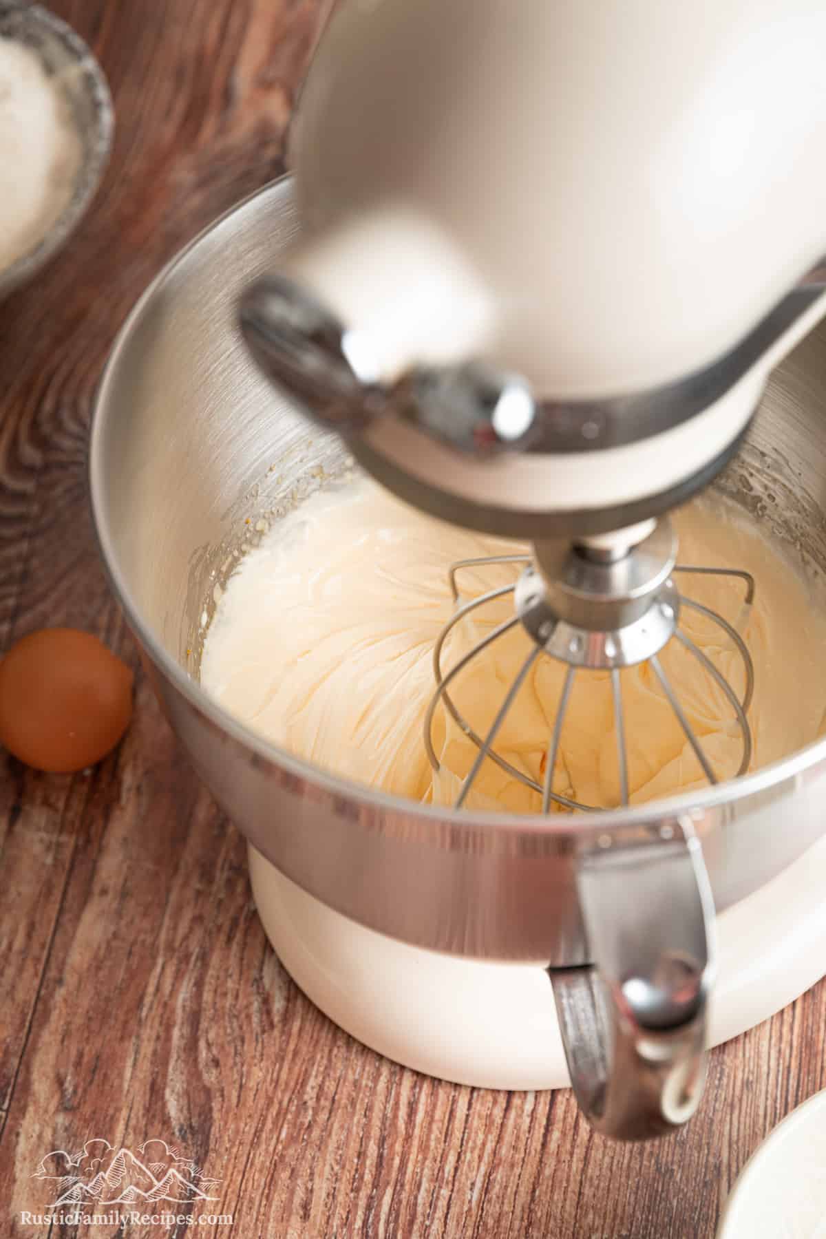 Sugar and eggs being beat in a stand mixer