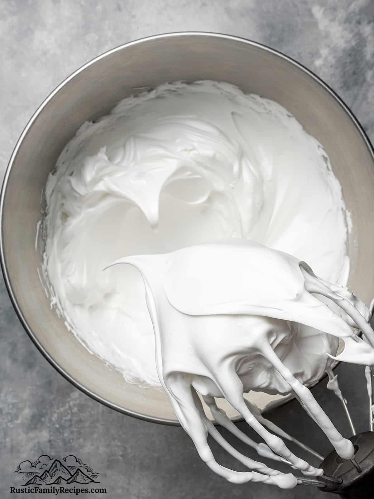 Stand mixer bowl with whisk attachment and meringue 