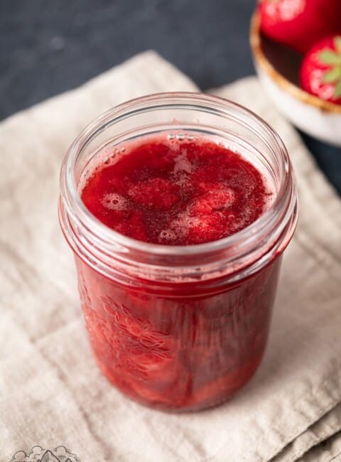 Mason jar filled with strawberry sauce