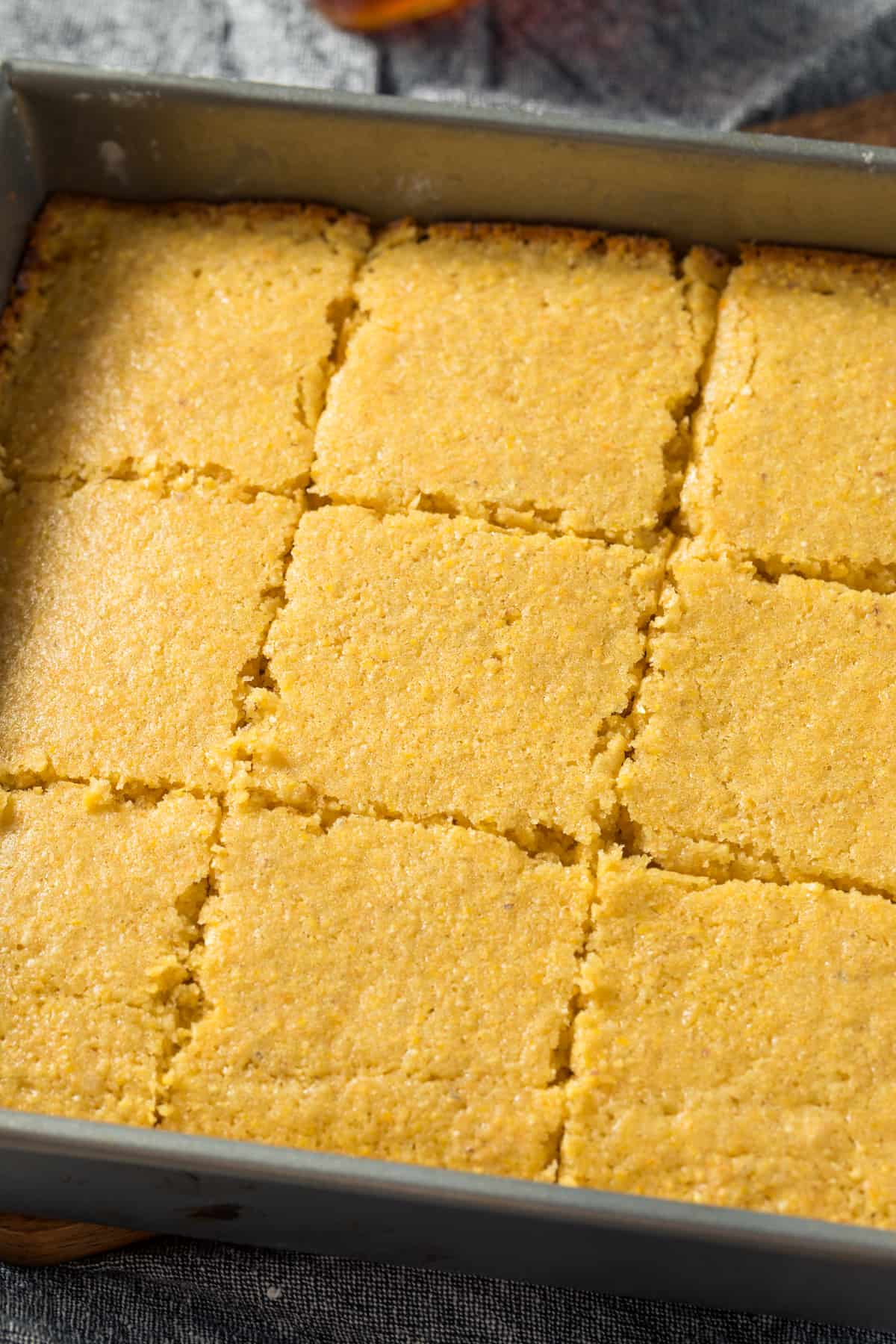 Cornbread in a baking dish with slices cut