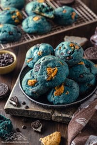 A plate piled with blue cookie monster cookies