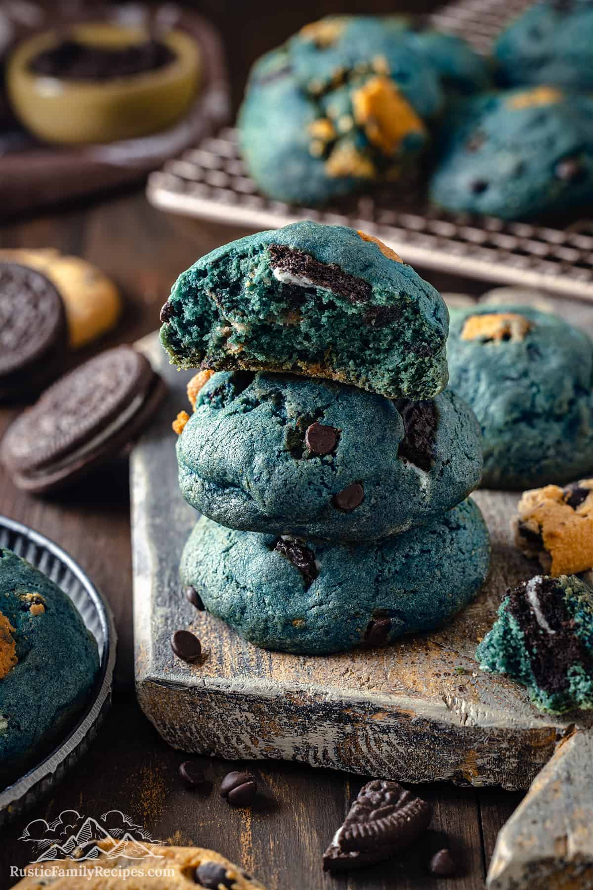 A stack of three cookie monster cookies, one broken in half