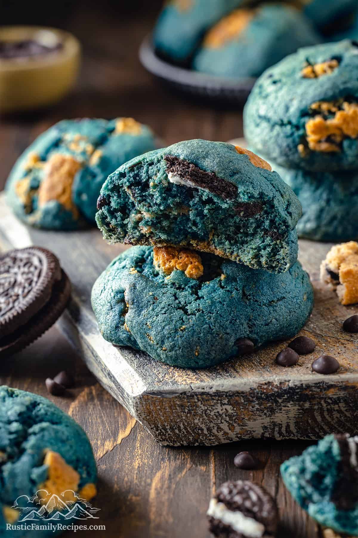 Two cookie monster cookies stacked, one broken in half