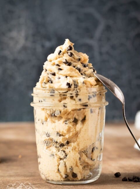 A mason jar with raw cookie dough