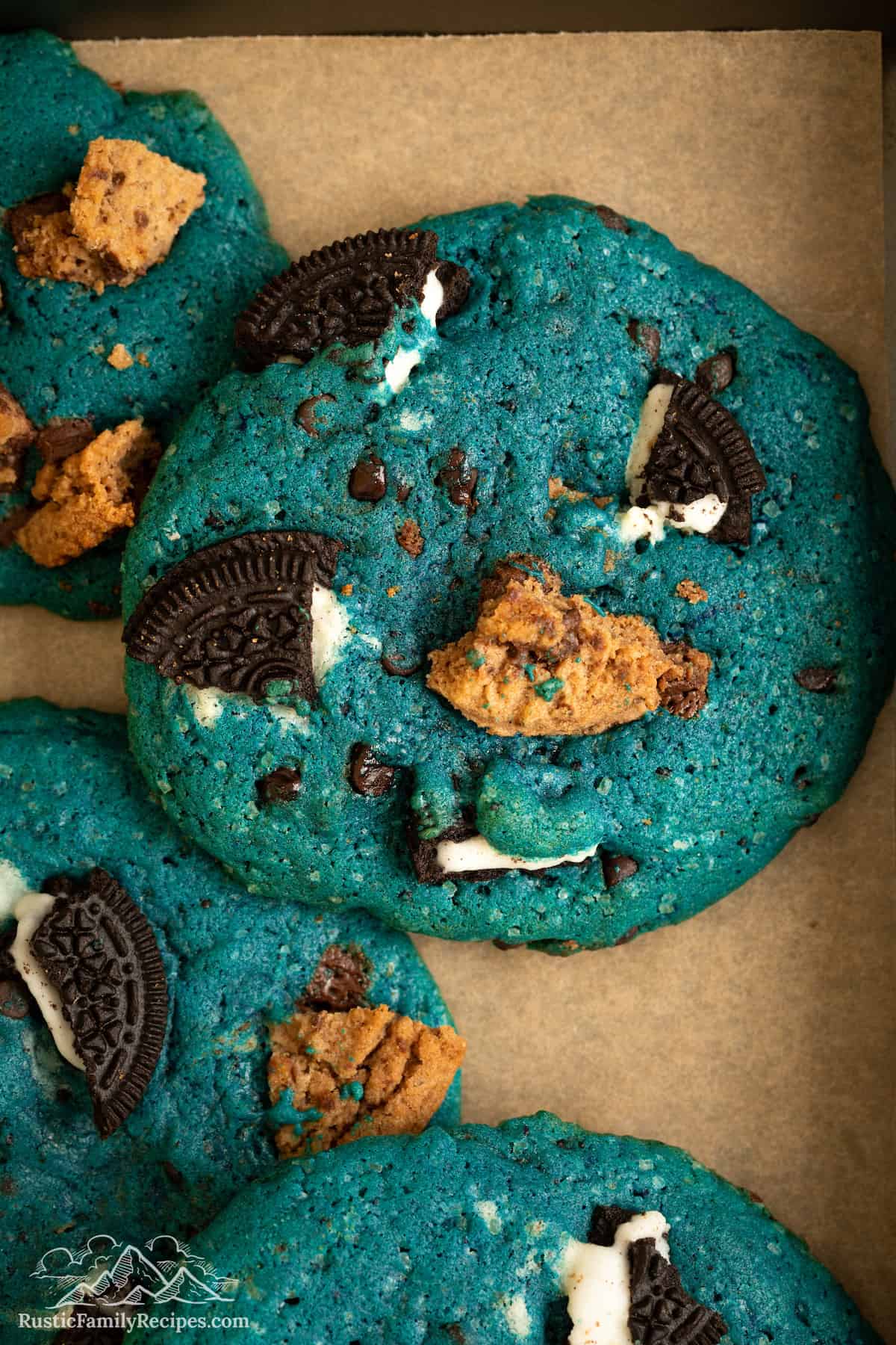 Close up of Cookie Monster cookies filled with chunks of Oreos and chocolate chip cookies.