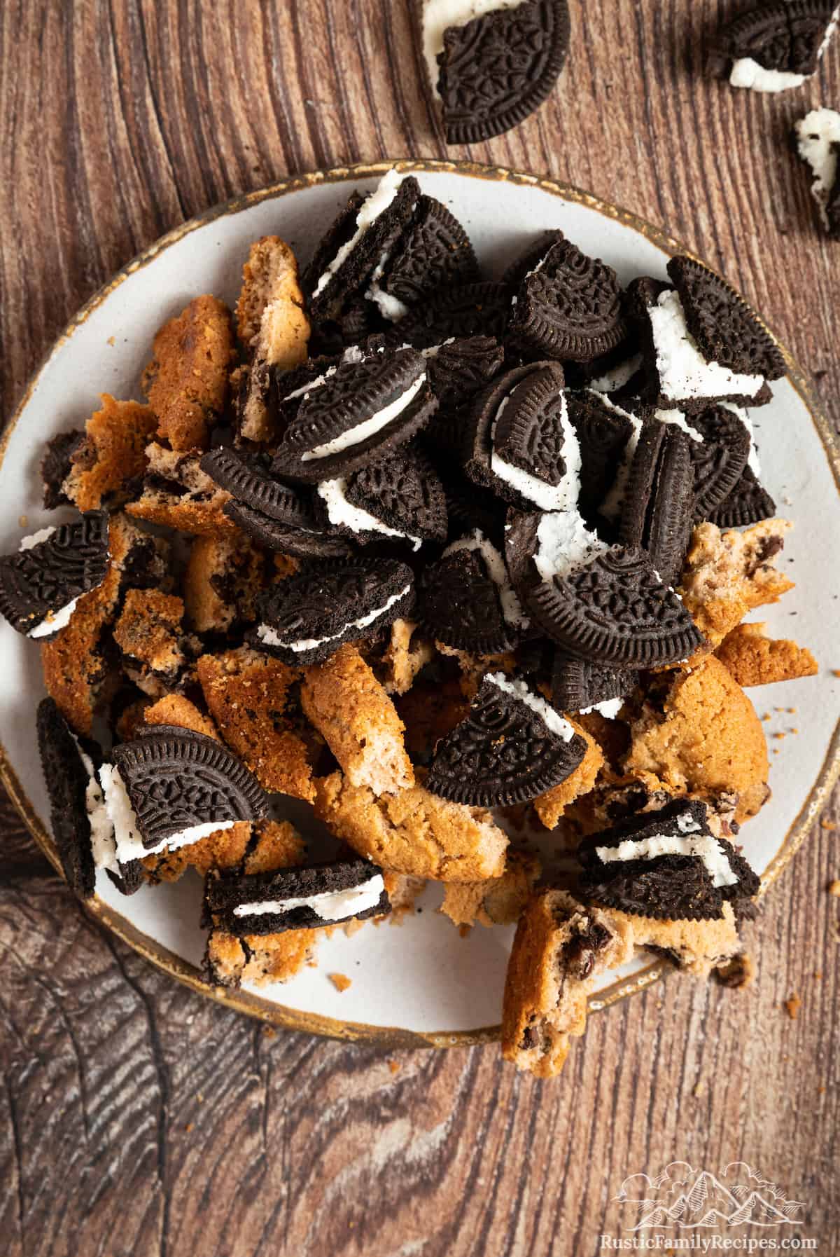 Chopped Oreos and chocolate chip cookies on a plate.