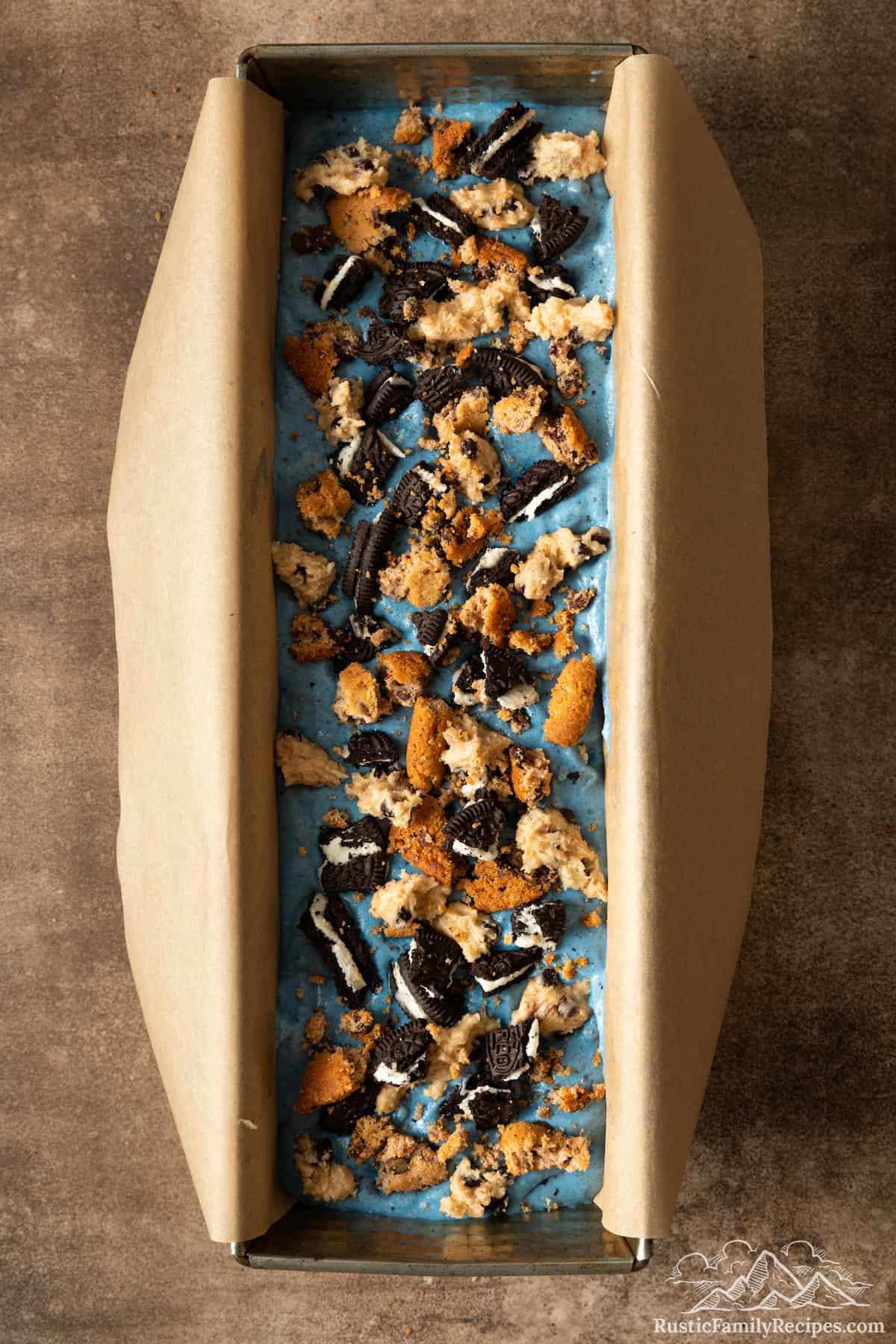 Cookie Monster ice cream topped with additional crumbled cookies and chunks of cookie dough.