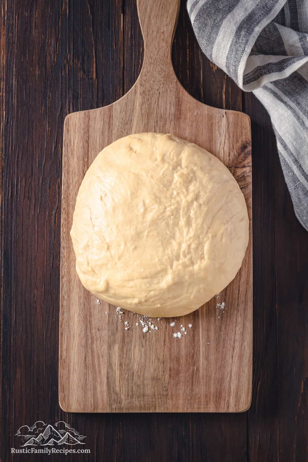 Top view of hojaldres dough on a wooden cutting board.
