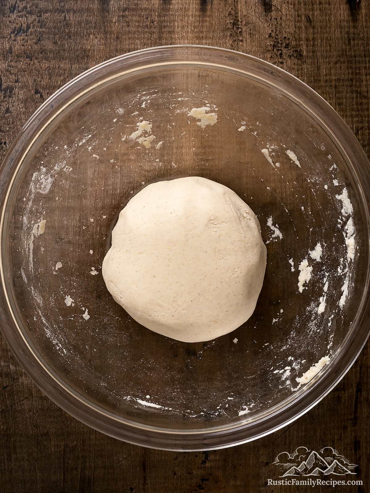 A ball of masa dough in a glass bowl.