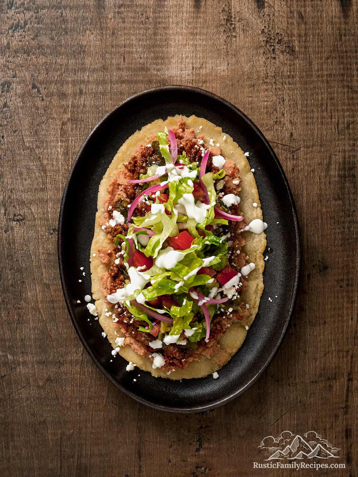 Huaraches topped with various toppings.