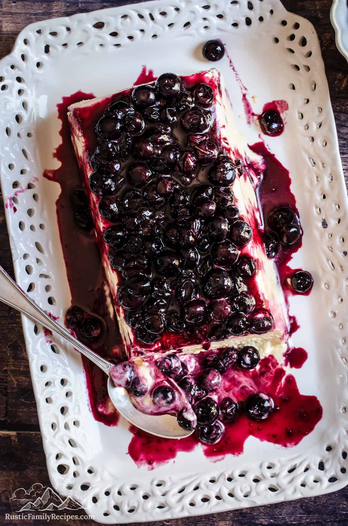 Top view of lemon blueberry semifreddo on a plate topped with homemade blueberry sauce.