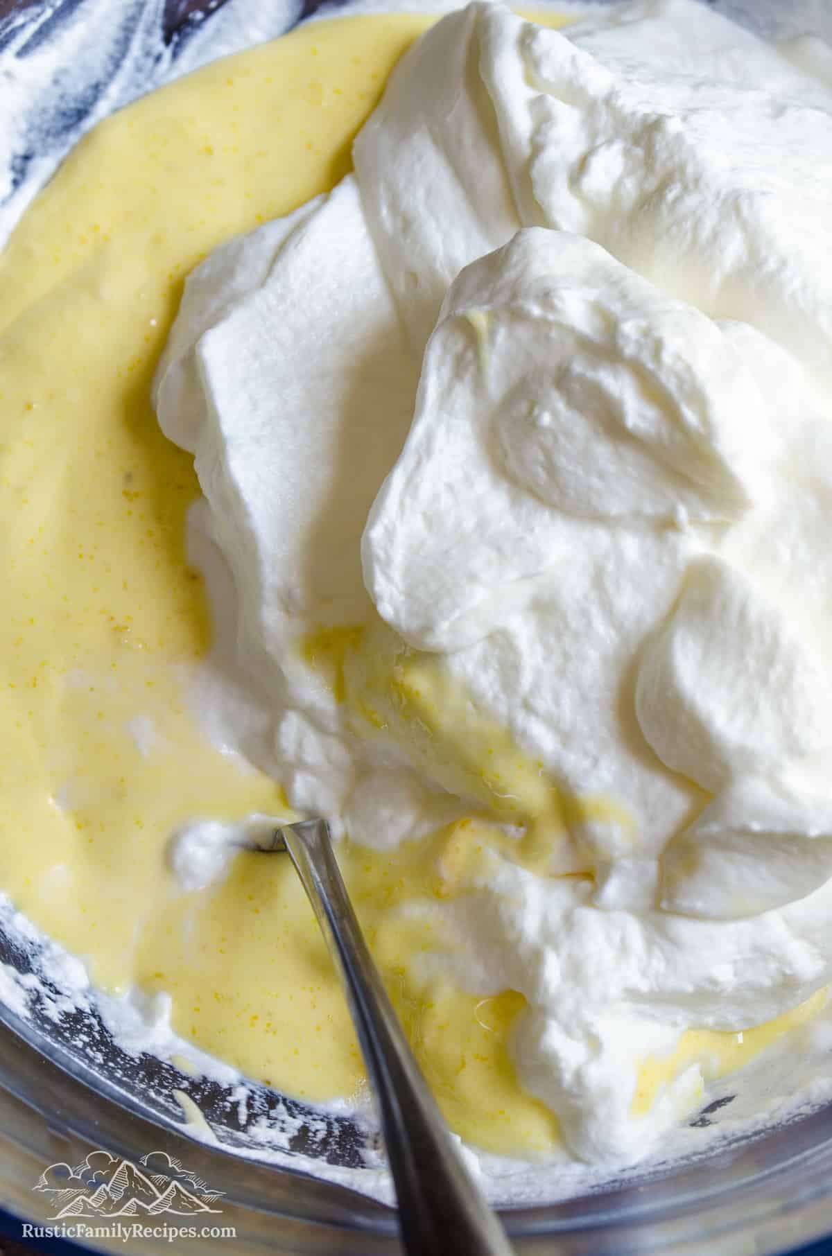 Chilled whipped cream is folded into the lemon semifreddo mixture.