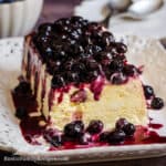 Lemon blueberry semifreddo on a plate topped with homemade blueberry sauce.