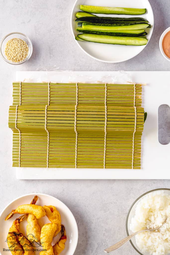 Bamboo mat on top of the avocado-topped roll.