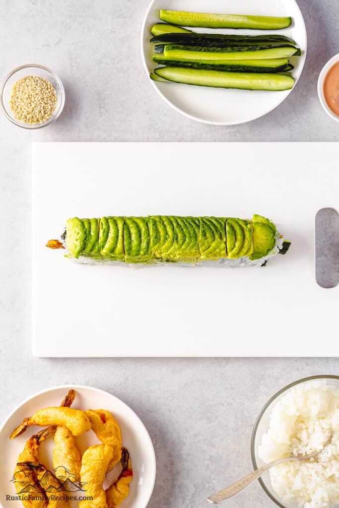 Sliced dragon roll topped with avocado.