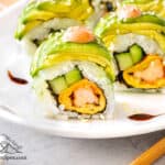 Dragon roll with spicy mayo and sesame seeds.